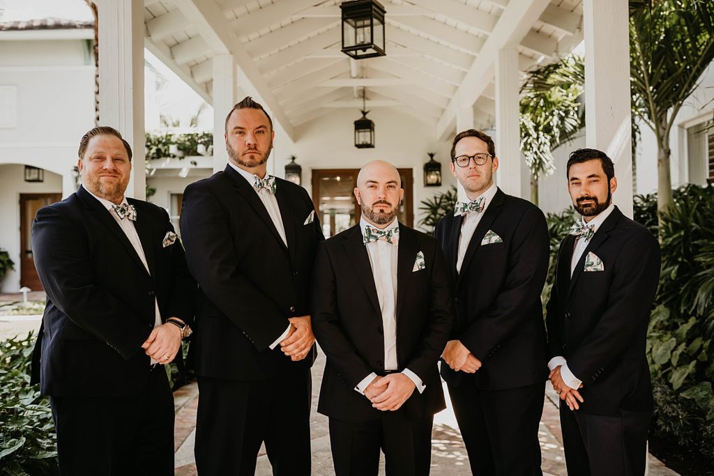 Groom posing with groomsmen under breezeway Pelican Club Wedding Photography captured by South Florida Wedding Photographer Krystal Capone Photography 