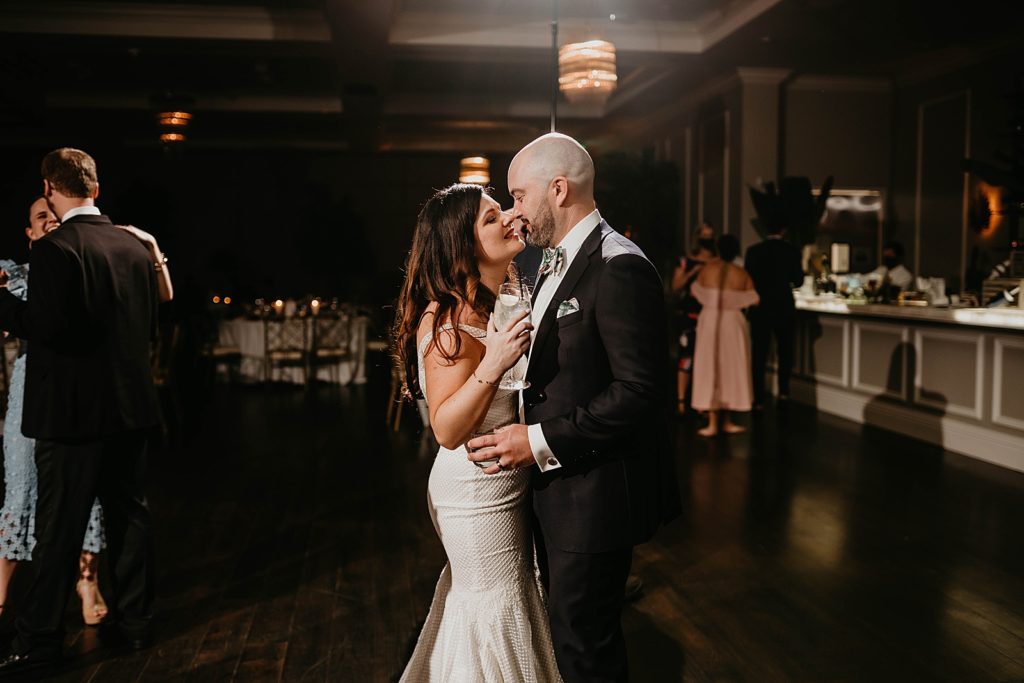 Bride and Groom about to kiss with drinks in hand Pelican Club Wedding Photography captured by South Florida Wedding Photographer Krystal Capone Photography 