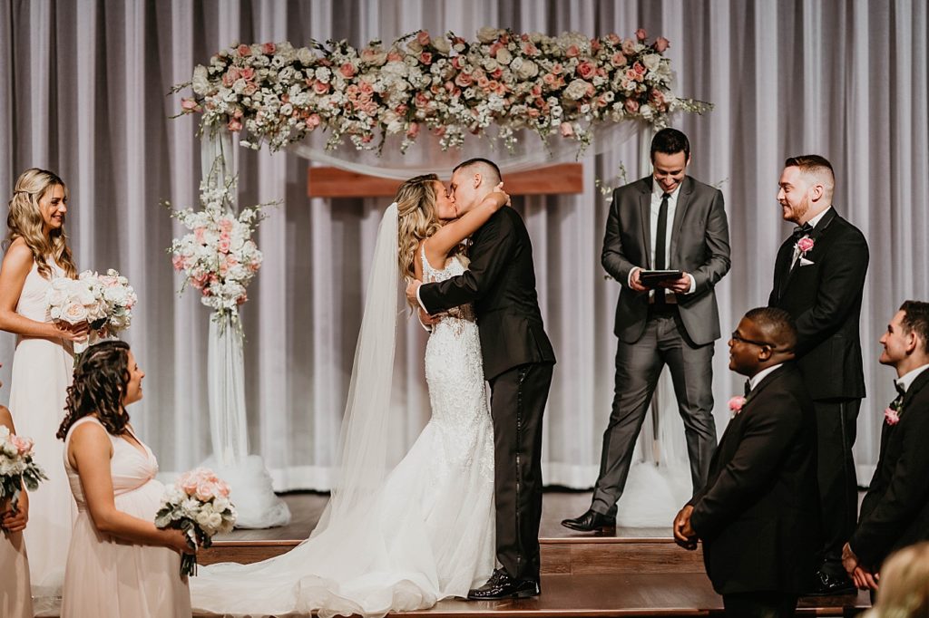 Just married Bride and Groom kissing Ceremony Pelican Club Wedding Photography captured by South Florida Wedding Photographer Krystal Capone Photography