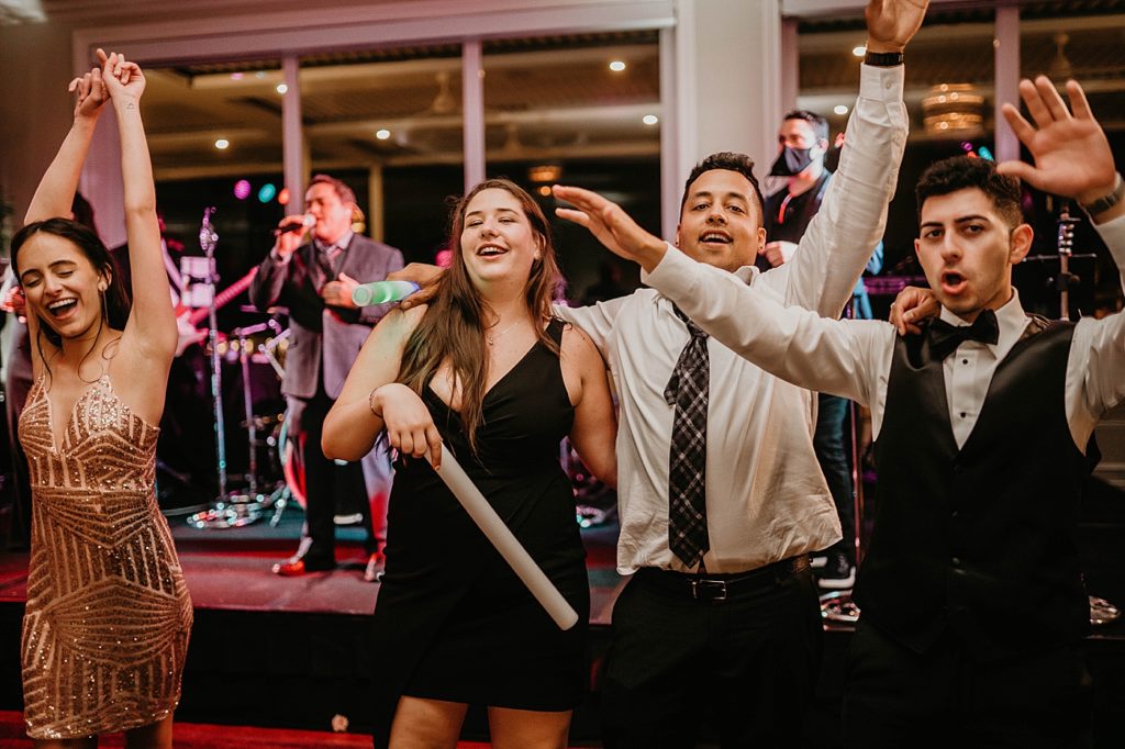 Dancing in front of band Reception Pelican Club Wedding Photography captured by South Florida Wedding Photographer Krystal Capone Photography