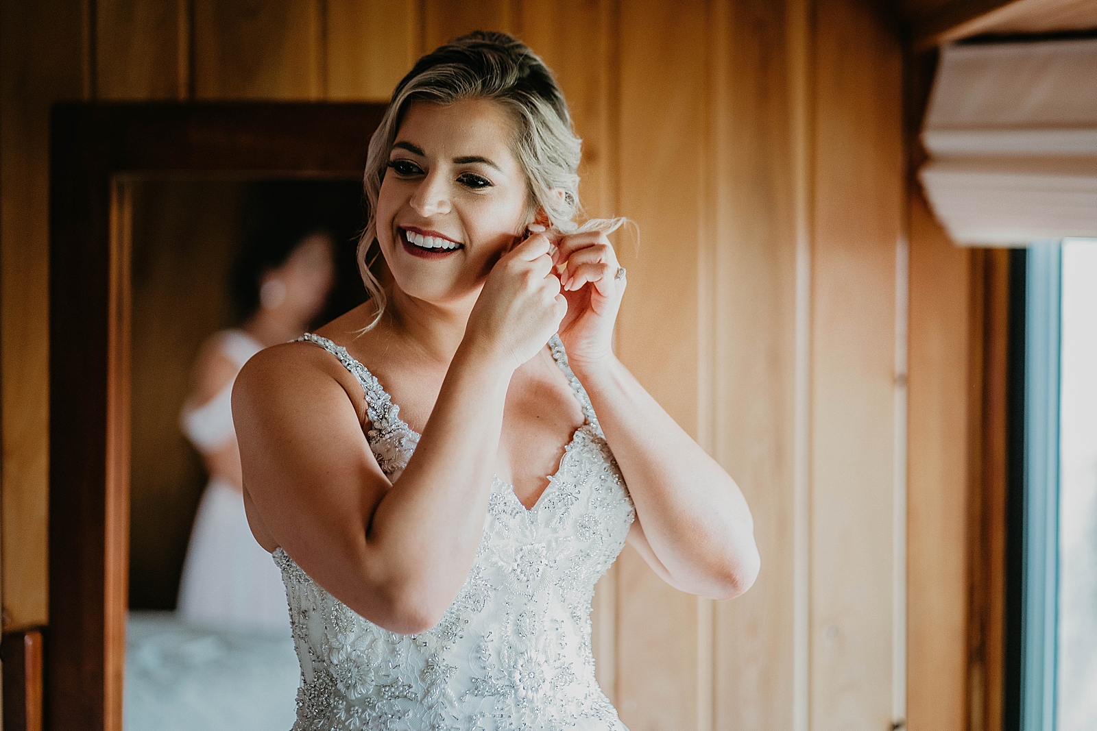 Bride getting ready putting earrings on