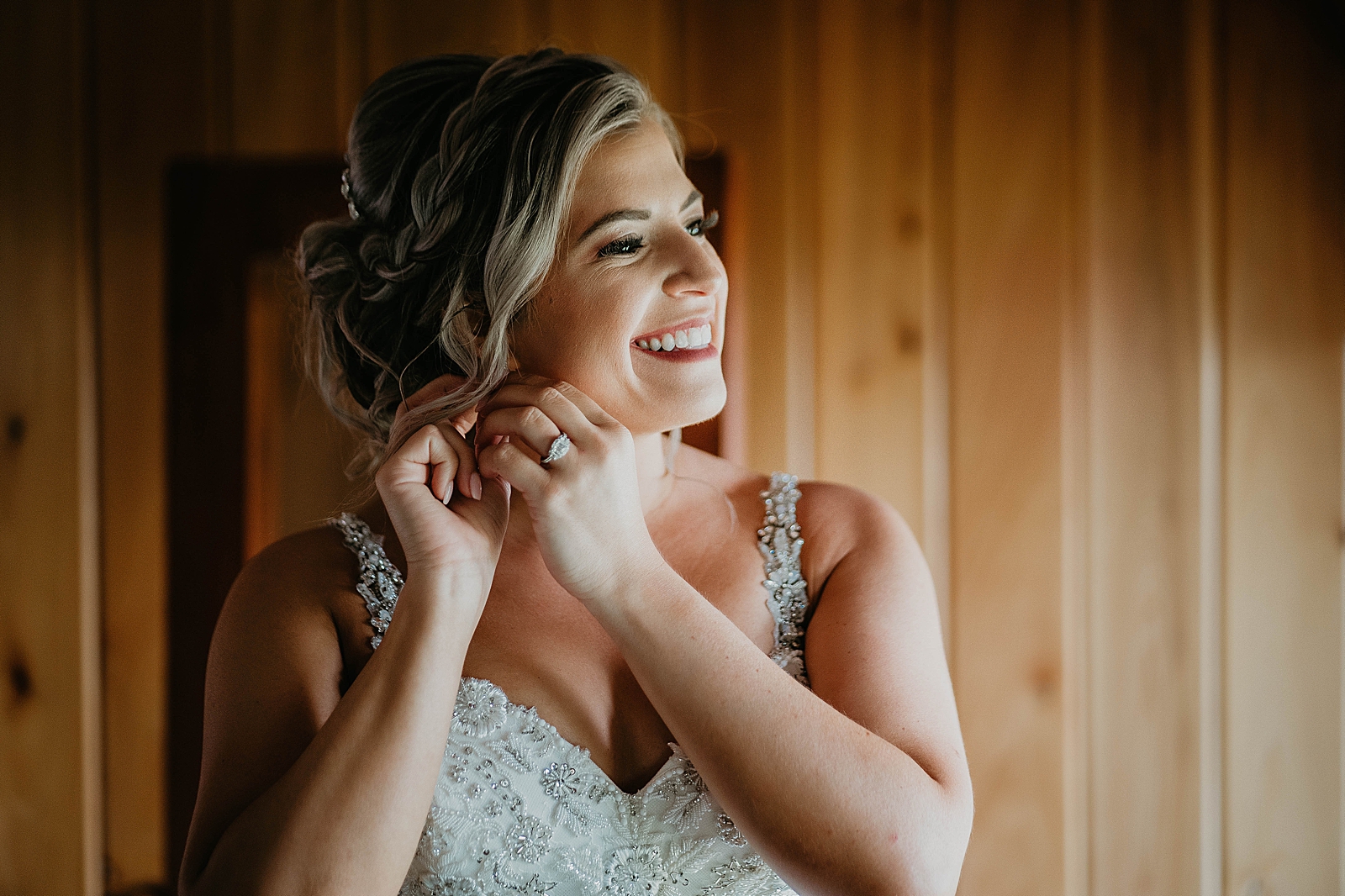 Bride putting earrings on getting ready