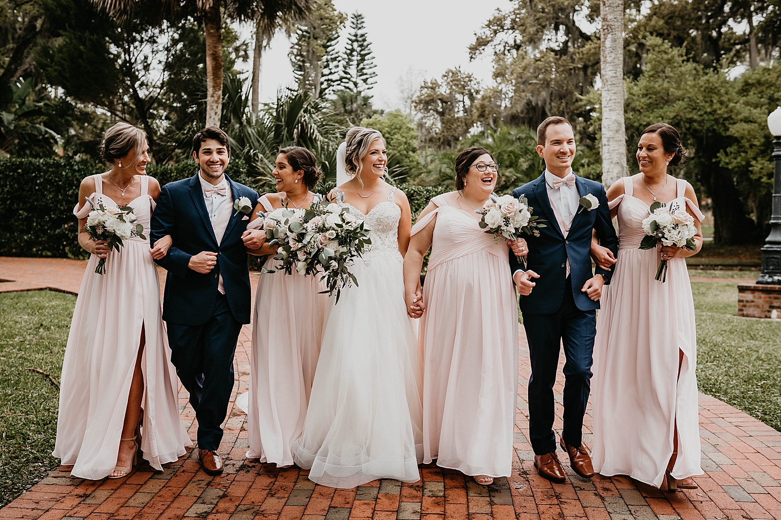 Bride and Bridesmaids arm in arm portrait