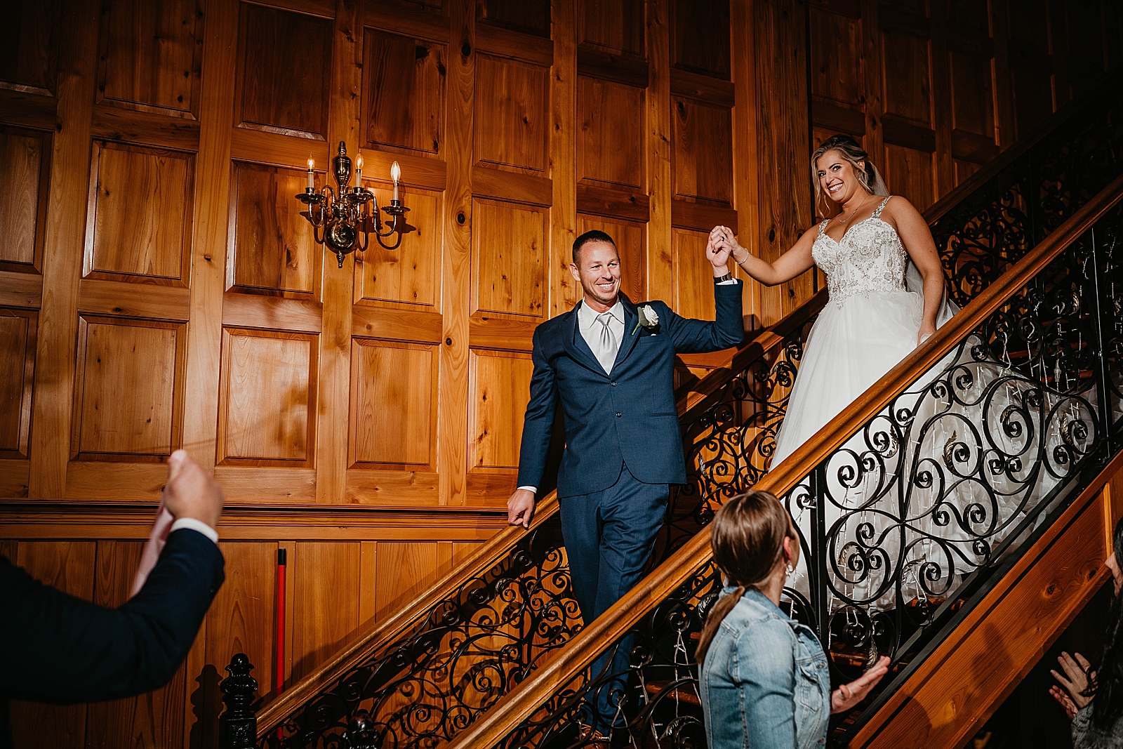 Bride and Groom walking down staircase for the Reception