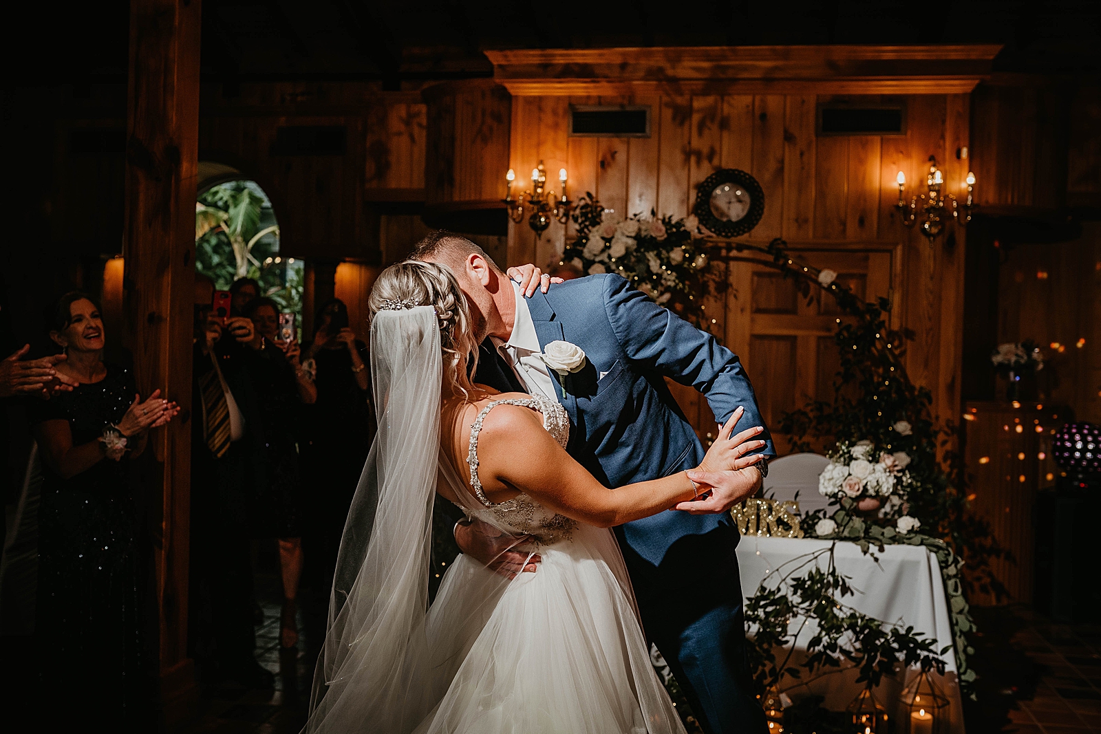 Bride and Groom kissing entering the Reception