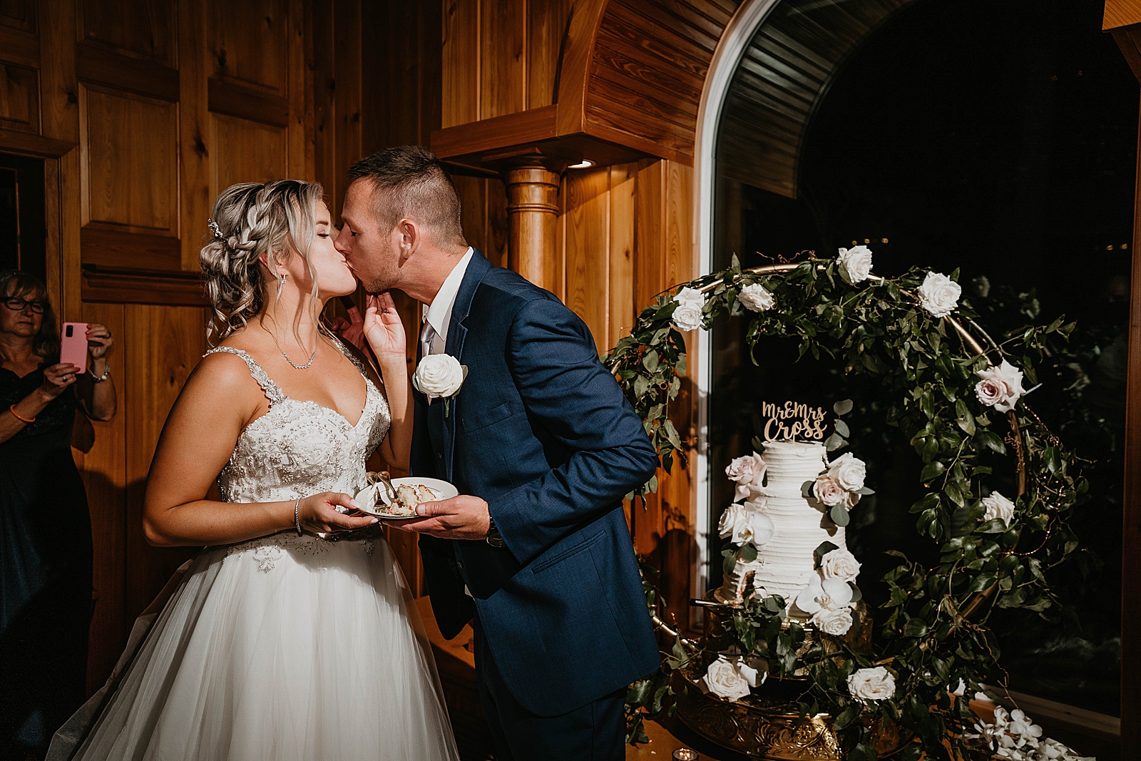 Bride and Groom kissing after tasting the cake