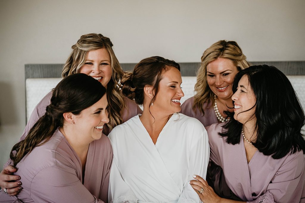 Bride with Bridesmaids smiling before getting ready