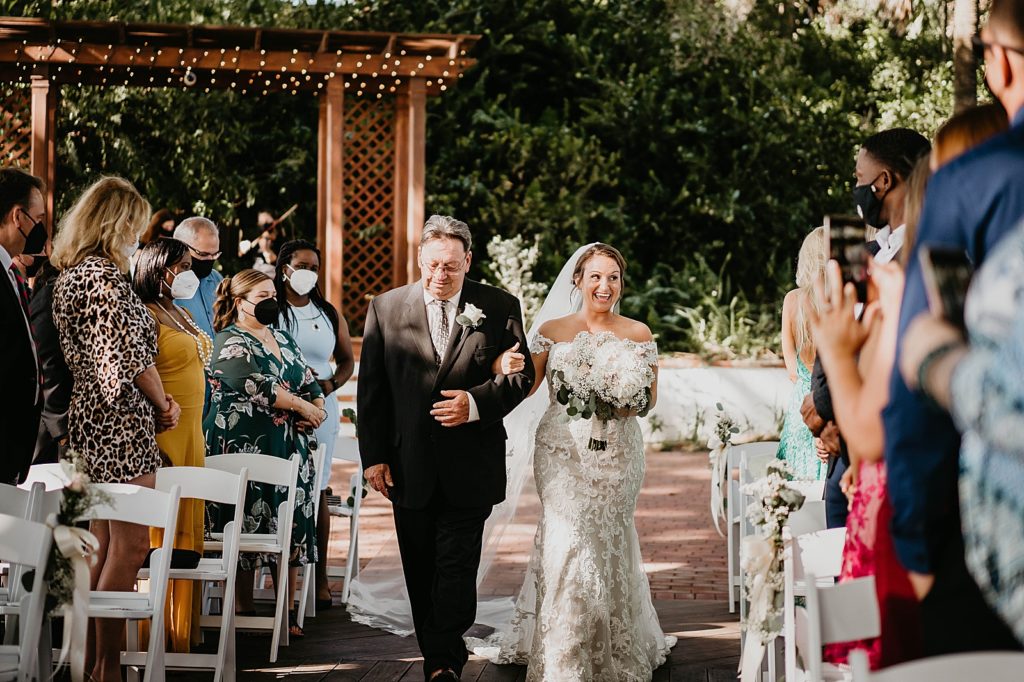 Bride entering Ceremony with father and Guests in face masks