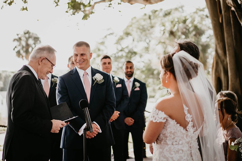 Bride and Groom listening to Homily for Ceremony