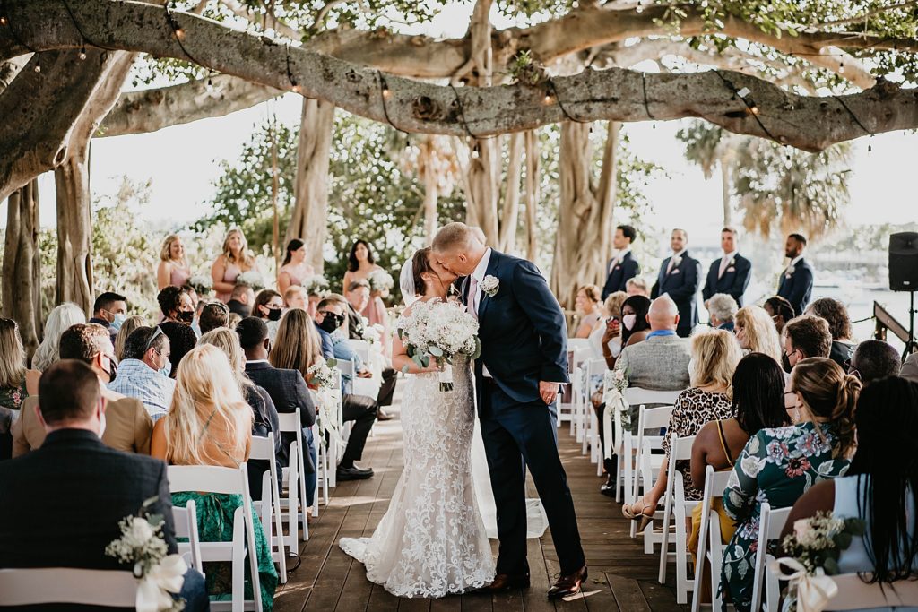 Bride and Groom kissing halfway through Ceremony exit