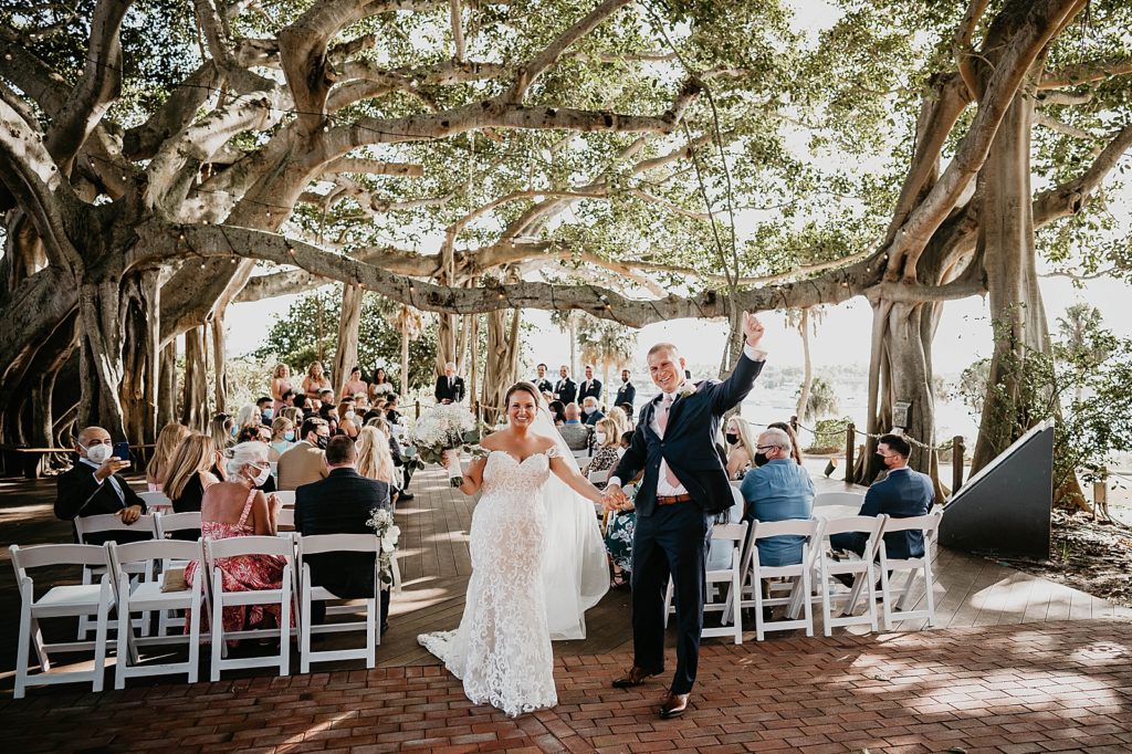 Bride and Groom celebratory pose after Ceremony exit