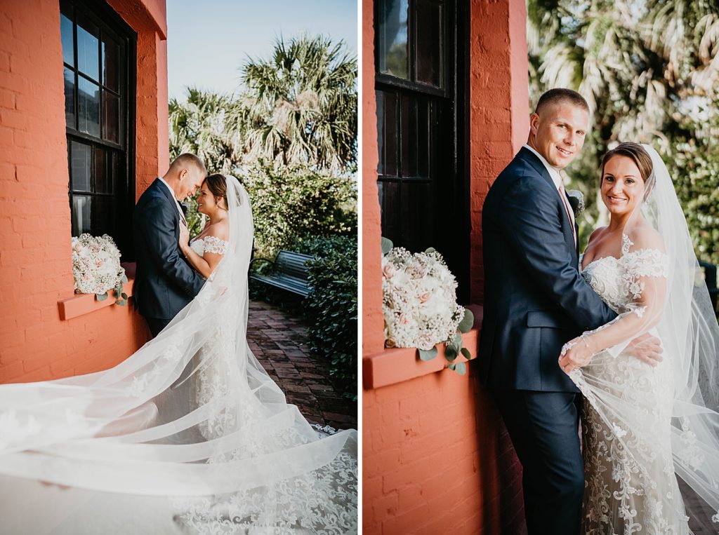 Bride and Groom nuzzling while veil is flowing in the air
