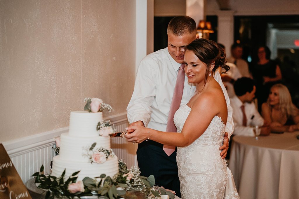 Bride and Groom cutting cake at Reception