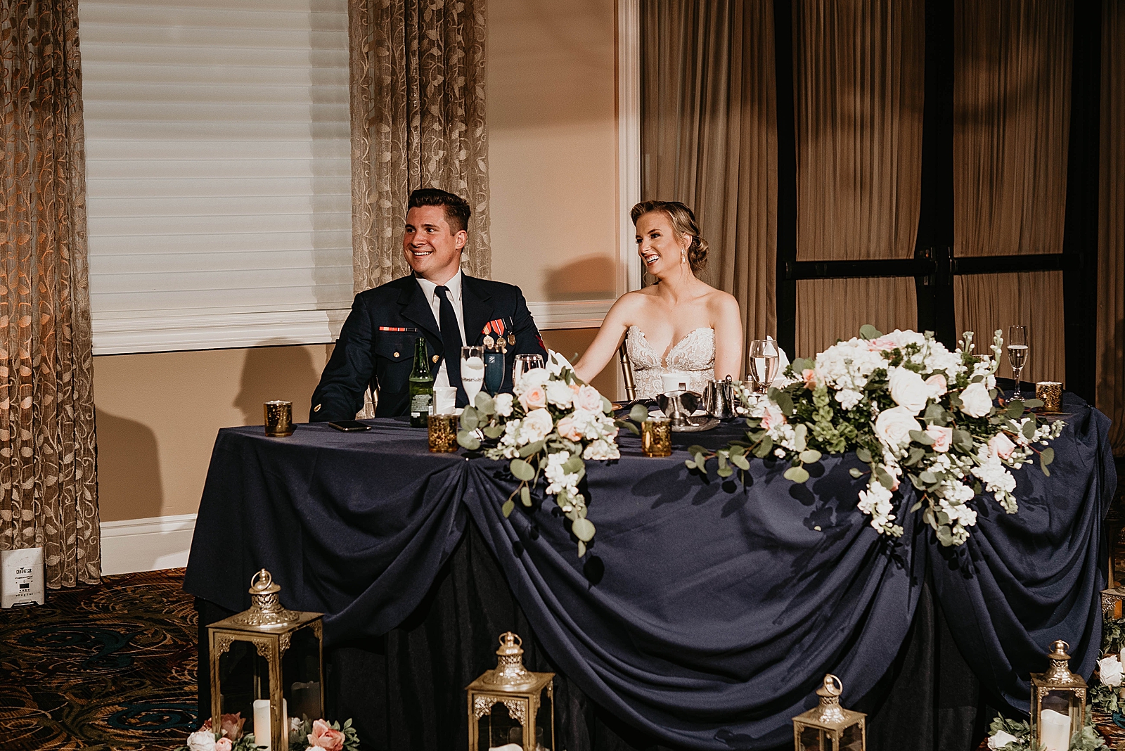 Bride and Groom listening to toast speech at sweetheart table